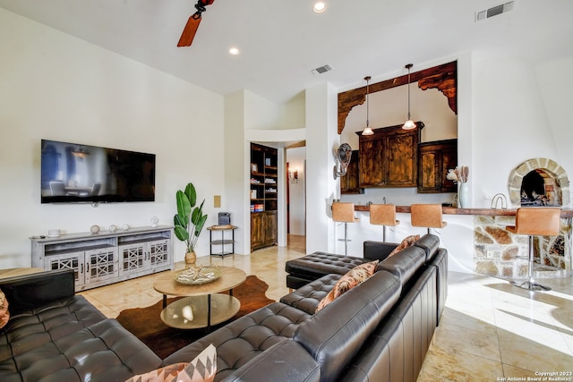 living room with built in shelves, visible vents, a ceiling fan, and recessed lighting