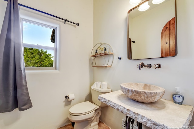 half bath featuring a sink and toilet