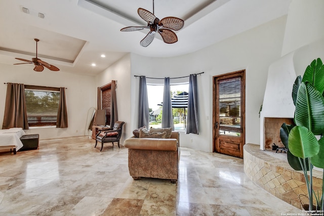 sitting room with a tray ceiling, ceiling fan, and recessed lighting