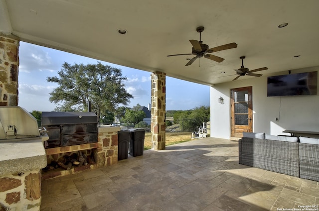 view of patio with outdoor lounge area, ceiling fan, an outdoor kitchen, and grilling area