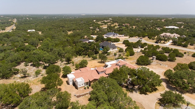 drone / aerial view featuring a wooded view