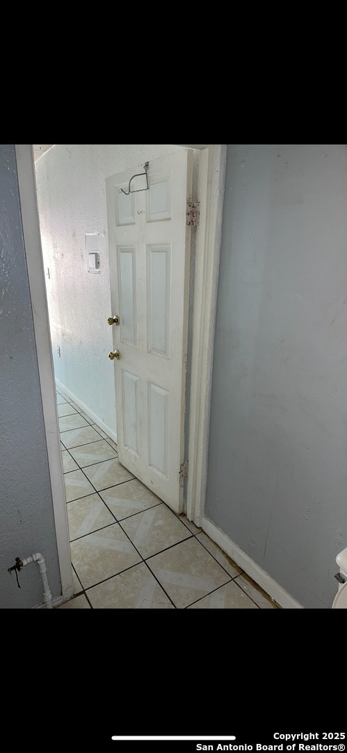 corridor featuring light tile patterned flooring