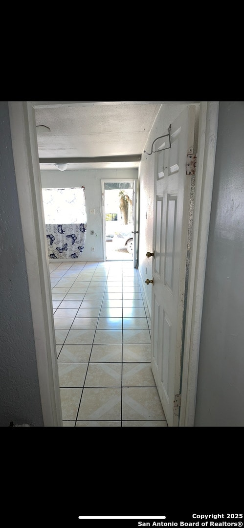 hallway featuring light tile patterned floors