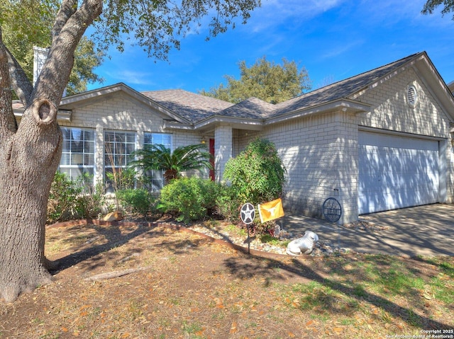 ranch-style home with a garage, concrete driveway, and brick siding