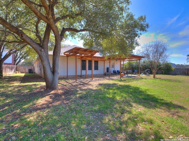 view of yard featuring a patio area, a fenced backyard, and a pergola