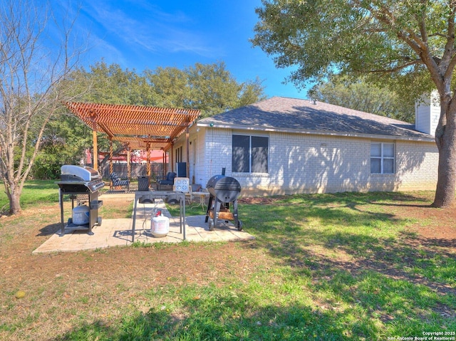 back of property featuring a lawn, a chimney, a patio area, a pergola, and brick siding