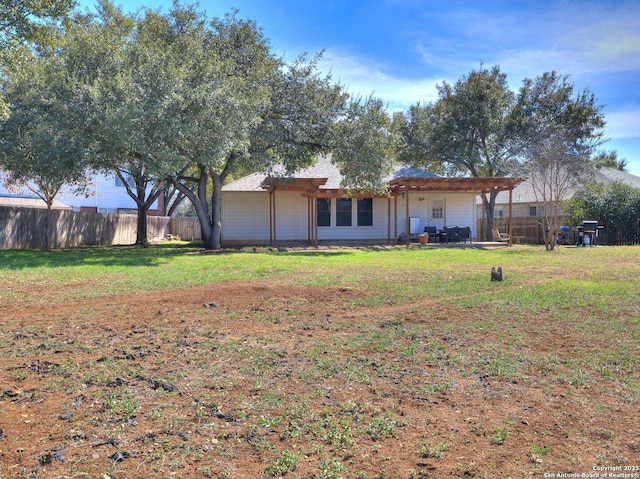 view of front facade with a patio, a front yard, and fence