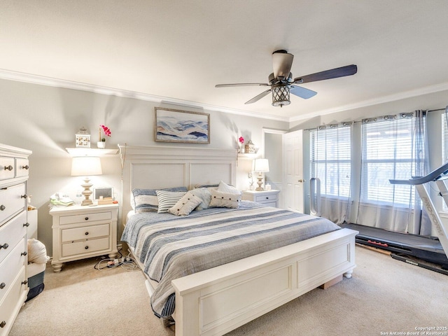 bedroom featuring crown molding, a ceiling fan, and light colored carpet