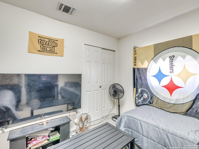 bedroom with a closet and visible vents