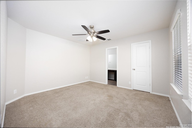 unfurnished bedroom with ensuite bath, carpet flooring, visible vents, and baseboards