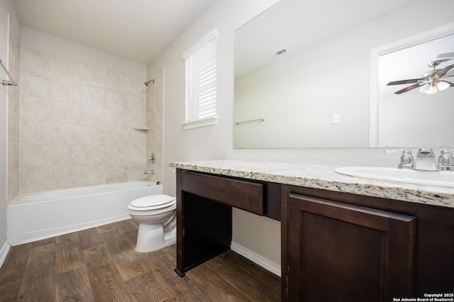 bathroom featuring bathtub / shower combination, toilet, wood finished floors, vanity, and visible vents