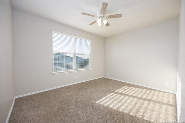 unfurnished room with carpet floors, ceiling fan, and baseboards