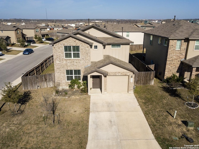 traditional-style home with brick siding, fence, a garage, a residential view, and driveway