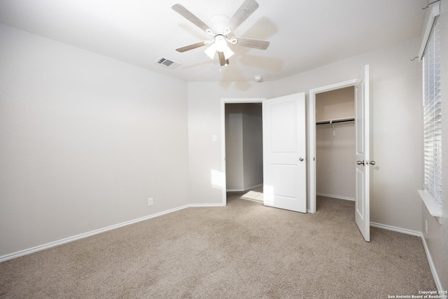 unfurnished bedroom featuring a closet, visible vents, light carpet, and baseboards