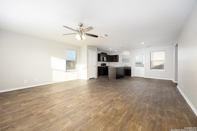 unfurnished living room featuring recessed lighting, visible vents, a ceiling fan, baseboards, and dark wood-style floors