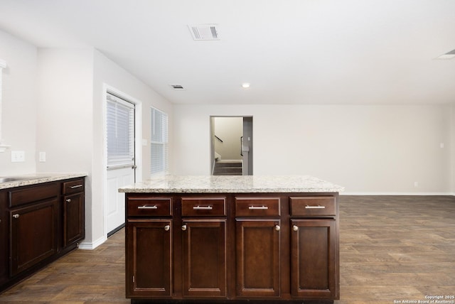 kitchen with visible vents, dark wood finished floors, dark brown cabinetry, and baseboards