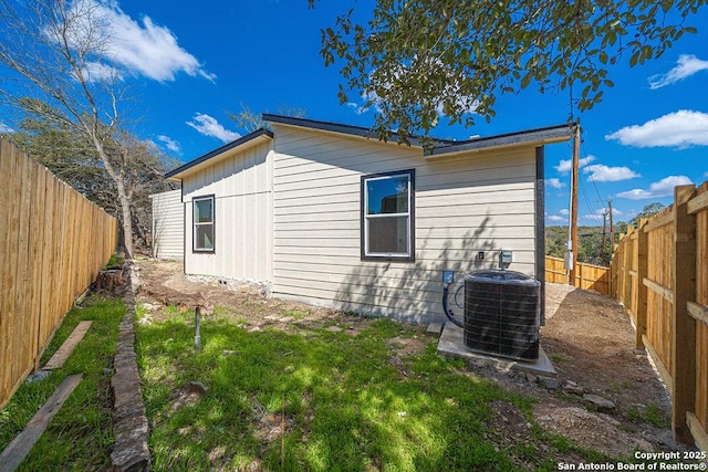 exterior space with a fenced backyard and cooling unit