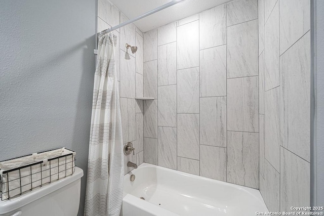 bathroom featuring toilet, shower / bath combo, and a textured wall