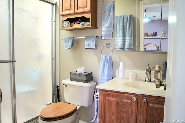 full bath featuring a stall shower, vanity, and toilet