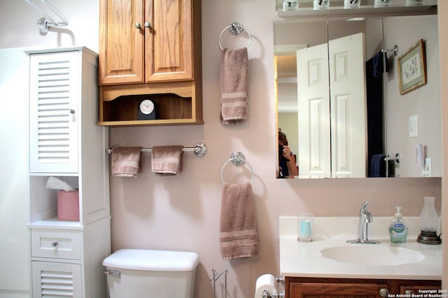 bathroom with toilet and vanity