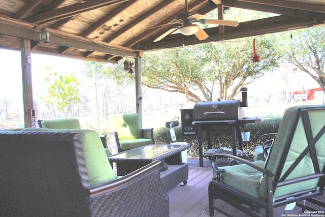 wooden terrace featuring ceiling fan and fence