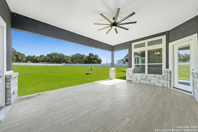 view of patio with a ceiling fan and a deck with water view