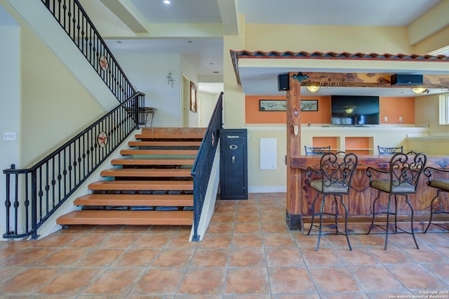 stairs with tile patterned floors, recessed lighting, and baseboards