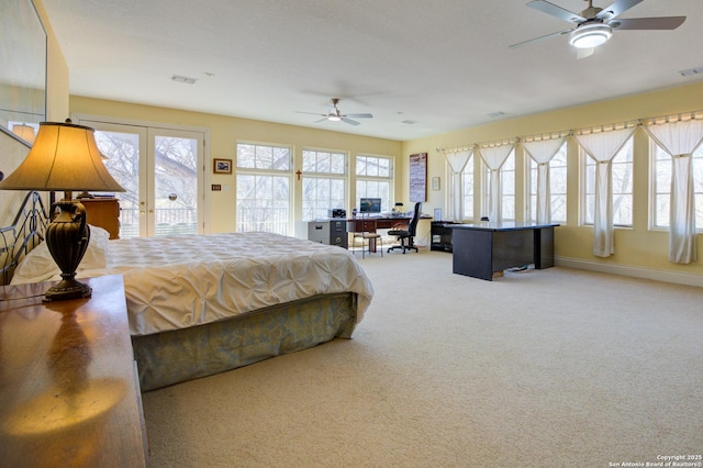 carpeted bedroom featuring access to exterior, multiple windows, and visible vents