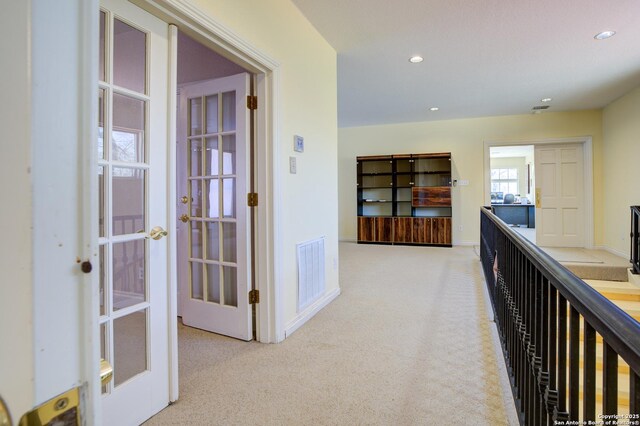 hall with visible vents, carpet floors, baseboards, recessed lighting, and french doors