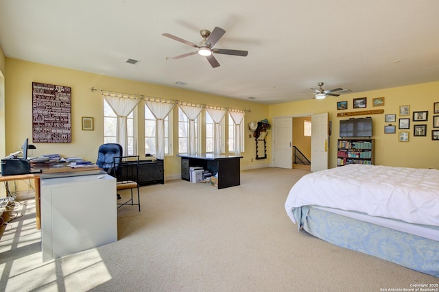 bedroom featuring visible vents, light colored carpet, a ceiling fan, and baseboards