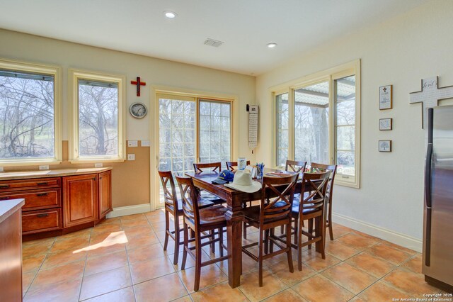 dining area featuring light tile patterned floors, visible vents, baseboards, and recessed lighting