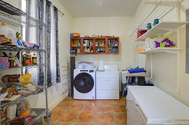 washroom with laundry area, light tile patterned floors, and washer and clothes dryer