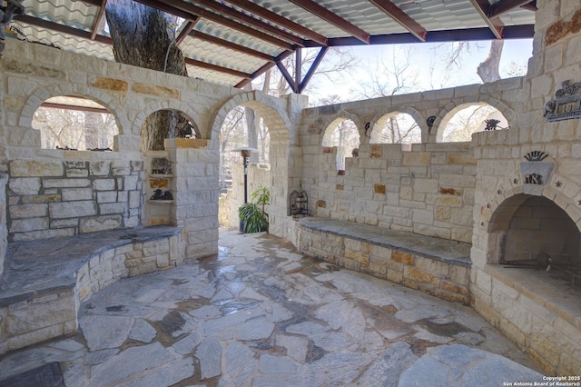 view of patio with an outdoor stone fireplace