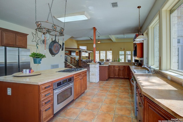 kitchen featuring visible vents, light countertops, light tile patterned floors, appliances with stainless steel finishes, and a sink