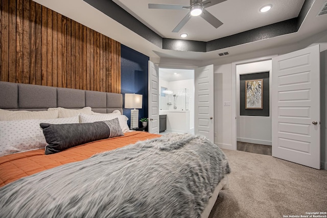 carpeted bedroom featuring recessed lighting, baseboards, visible vents, and ensuite bath