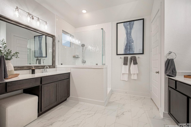 full bath with marble finish floor, a walk in shower, and vanity