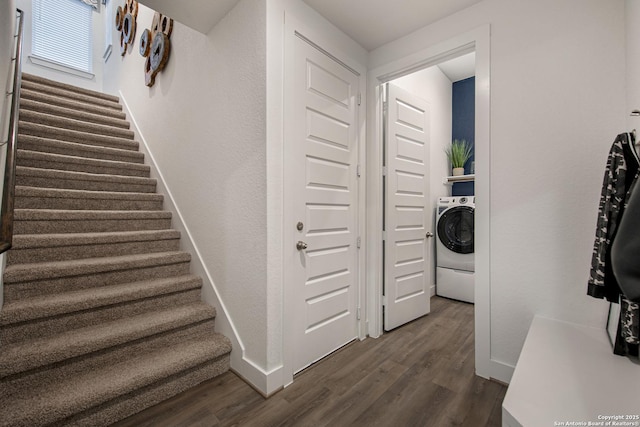 staircase featuring washer / clothes dryer, wood finished floors, and baseboards