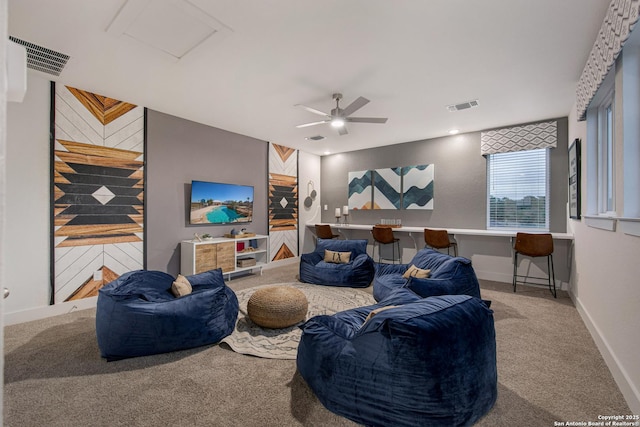 carpeted living area featuring attic access, visible vents, and baseboards