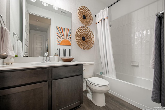 full bathroom featuring toilet, wood finished floors, vanity, visible vents, and shower / bath combination with curtain