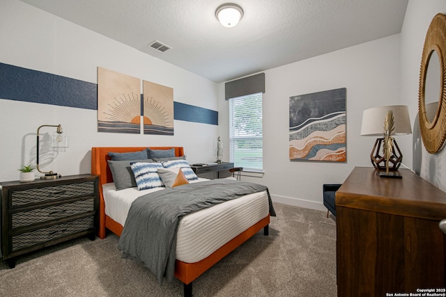 bedroom featuring a textured ceiling, carpet, visible vents, and baseboards