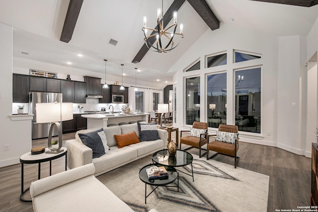 living area with visible vents, an inviting chandelier, dark wood-type flooring, high vaulted ceiling, and beamed ceiling