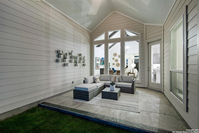 sunroom with a wealth of natural light and lofted ceiling