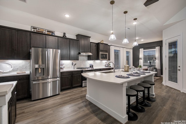 kitchen with stainless steel appliances, french doors, a sink, and light countertops