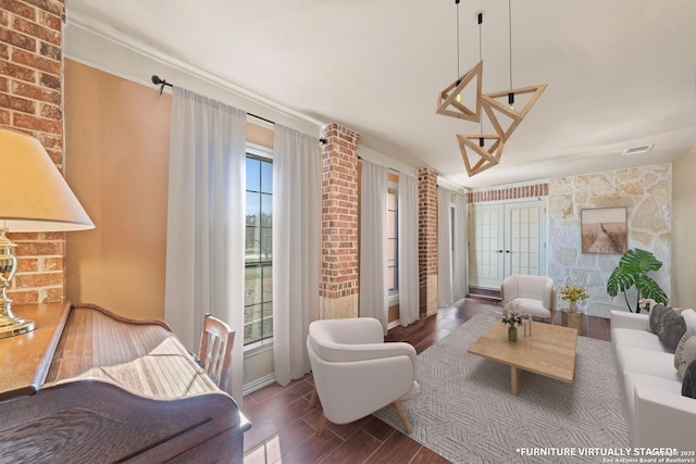 living room with wood tiled floor, visible vents, and french doors