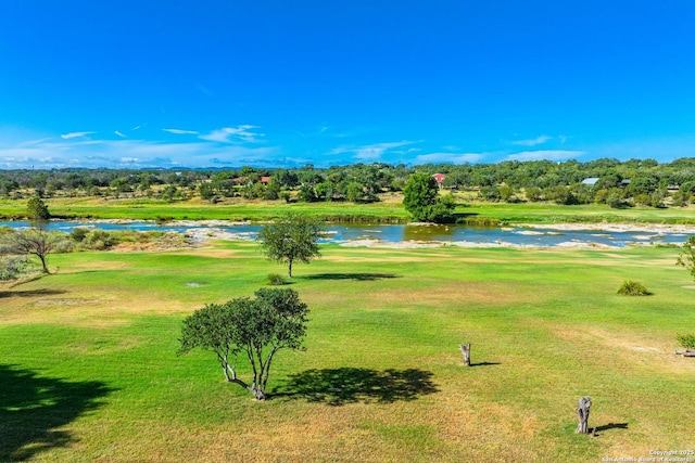 view of home's community with a yard and a water view