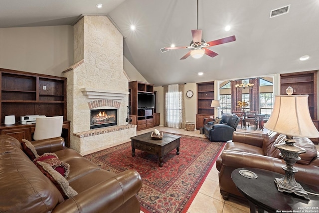 tiled living room with plenty of natural light, a fireplace, visible vents, and ceiling fan with notable chandelier