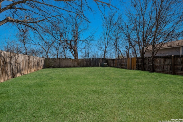 view of yard with a fenced backyard