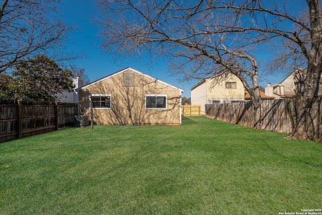 view of yard with central AC unit and a fenced backyard