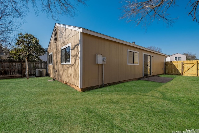 view of outbuilding with central AC and a fenced backyard