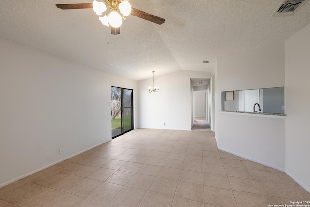 empty room with visible vents, vaulted ceiling, a sink, tile patterned flooring, and ceiling fan with notable chandelier